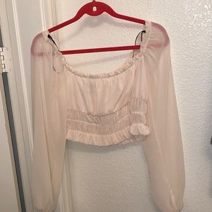 Ruched crop top with loose sheer sleeves.